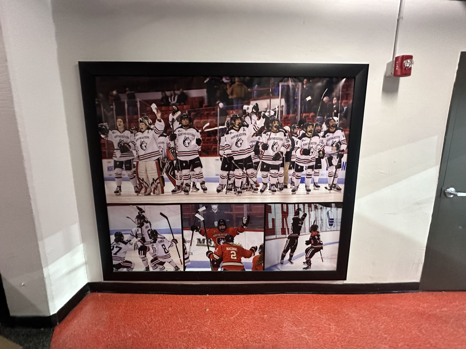 Framed athletic photo wall graphic in a rink hallway