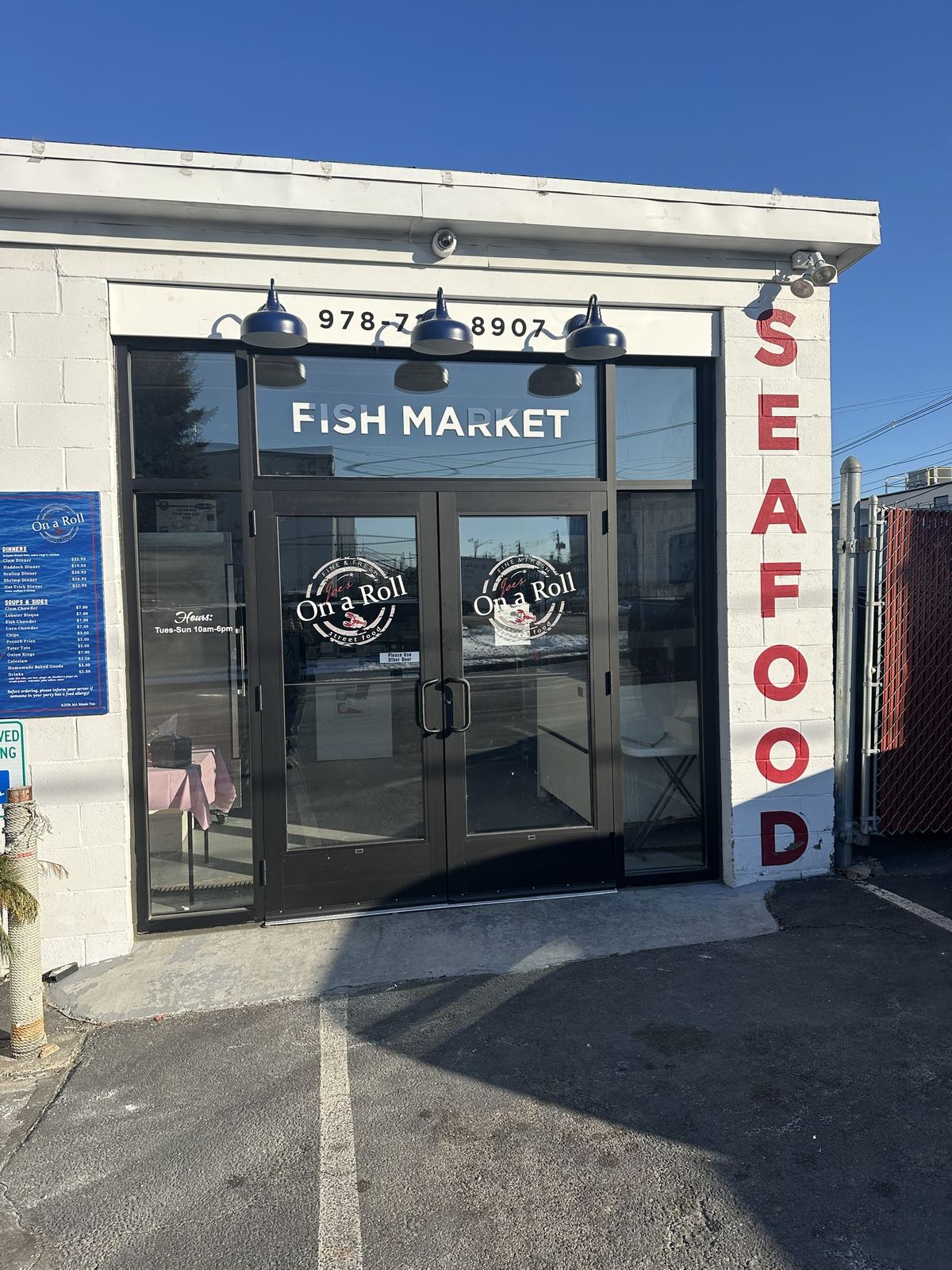 Door logos and window lettering on a seafood market