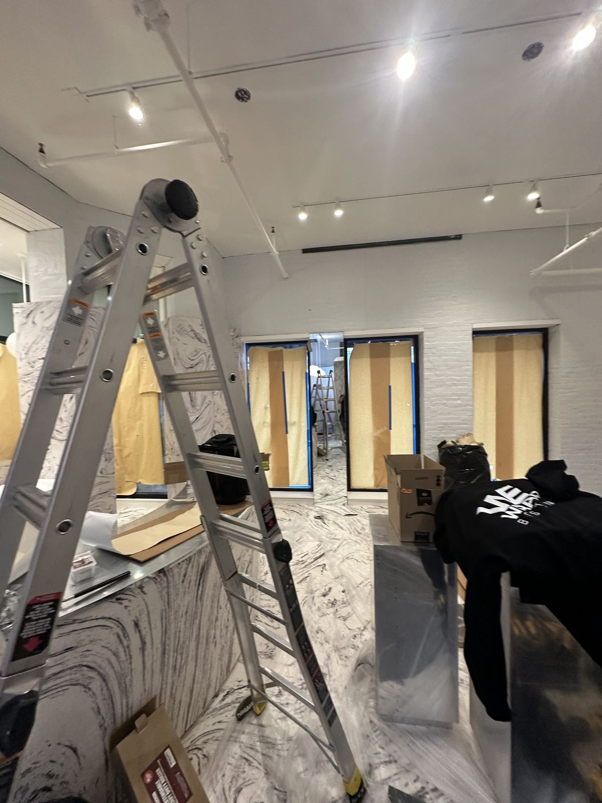 Retail interior wall wrap installation in progress